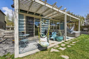 View of outdoor structure featuring fence and a pergola