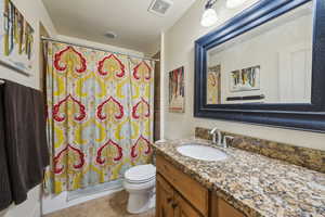 Bathroom featuring visible vents, tile patterned floors, toilet, and vanity