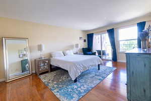 Bedroom featuring hardwood / wood-style floors and baseboards