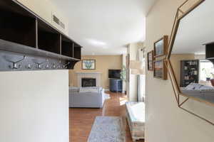 Hallway featuring visible vents and wood finished floors