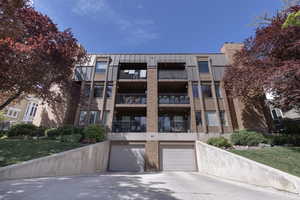 View of property featuring driveway and an attached garage