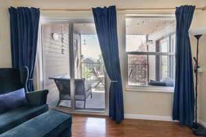 Entryway with baseboards and wood finished floors