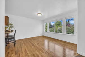 Unfurnished room featuring visible vents, baseboards, and light wood-type flooring