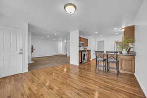 Living room featuring recessed lighting, baseboards, visible vents, and light wood-style floors