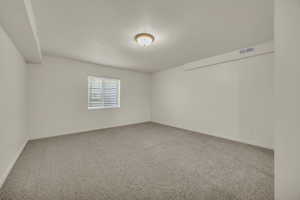 Carpeted lower level bedroom 4 featuring visible vents and baseboards
