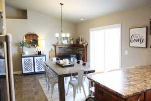 Dining space featuring a fireplace, a chandelier.