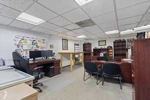 Office with carpet, a paneled ceiling, and visible vents
