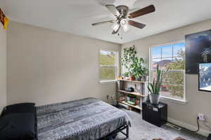 Bedroom featuring visible vents, carpet flooring, baseboards, and a ceiling fan