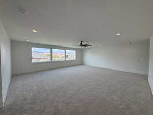 Spare room featuring carpet floors, baseboards, a ceiling fan, and recessed lighting
