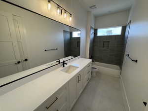 Full bath featuring vanity, visible vents, toilet, tile patterned floors, and shower / bath combination