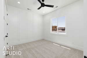 Carpeted empty room featuring a ceiling fan, baseboards, and recessed lighting