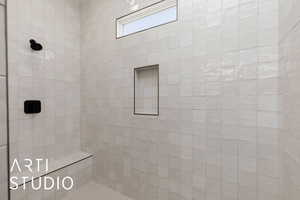 Bathroom featuring a tile shower