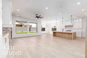 Kitchen with open floor plan, tasteful backsplash, a sink, recessed lighting, and light countertops