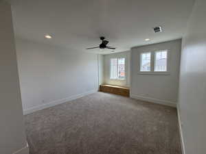 Carpeted empty room with a ceiling fan, baseboards, recessed lighting, and visible vents