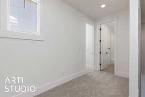Carpeted empty room with baseboards and recessed lighting