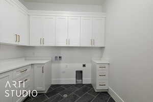 Laundry room with cabinet space, baseboards, hookup for a washing machine, and electric dryer hookup