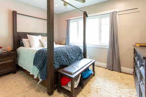 Bedroom featuring carpet floors, baseboards, and ceiling fan