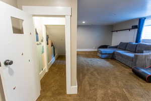 Carpeted living room featuring recessed lighting and baseboards