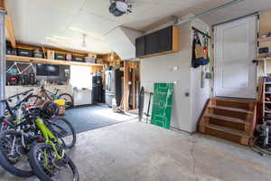 Garage with a garage door opener and freestanding refrigerator