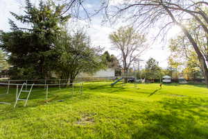 View of yard featuring fence
