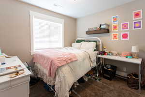 Bedroom with carpet floors and visible vents