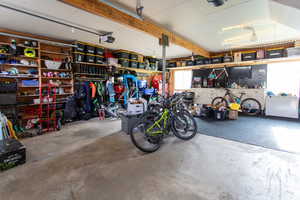 Garage featuring a garage door opener and a workshop area