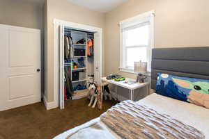 Bedroom featuring carpet and a closet