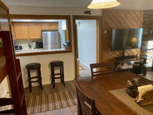 Dining room with baseboards and dark wood-style floors
