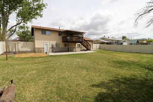 Back of house featuring a wooden deck, a gate, a patio area, stairway, and a fenced backyard