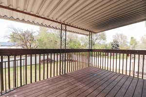 Wooden terrace with a lawn and fence