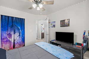 Carpeted bedroom featuring a ceiling fan