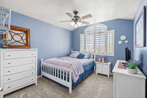 Bedroom with baseboards, carpet flooring, and a ceiling fan