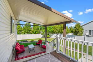 Deck with a lawn and a fenced backyard