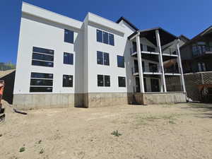 Rear view of house featuring stucco siding