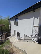 Rear view of house featuring stucco siding