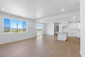 Interior space featuring baseboards, light wood-style flooring, and a sink