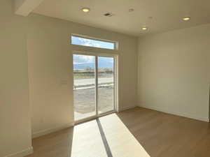 Empty room with visible vents, recessed lighting, light wood finished floors, and baseboards