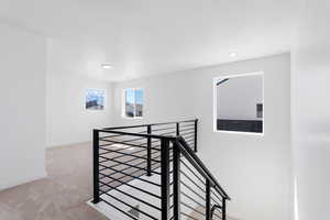 Stairs with recessed lighting, baseboards, and carpet floors
