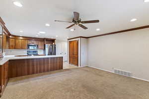 Kitchen with ceiling fan, light countertops, stainless steel appliances, recessed lighting, and visible vents