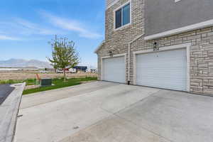 Garage featuring a mountain view and concrete driveway
