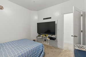 Carpeted bedroom featuring baseboards