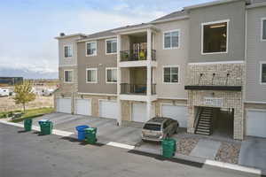 View of building exterior featuring driveway and a garage