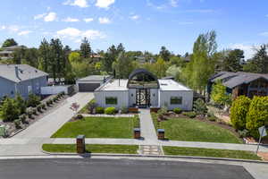 View of front of house featuring a garage, a residential view, and a front yard