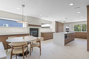 High end kitchen with Custom rift sawn white oak cabinetry with custom stain color, Silestone countertops that go up the wall, back splash, gas Wolf range with griddle, Sub zero fridge with water filter, Cabinet front dishwasher/bosch dishwasherBosch draw