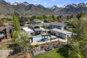 Exterior space featuring a mountain view, a residential view, a fenced backyard, and a patio area