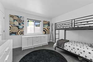 Bedroom featuring large closet and tile floors
