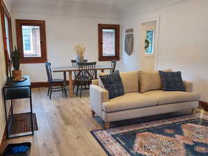 Living room with beautiful light wood-style floors and baseboards.