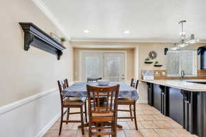 Dining area features doors leading to deck