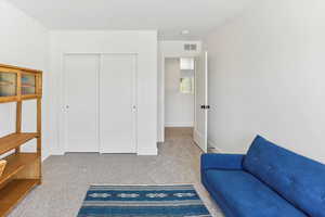 Living area featuring visible vents, baseboards, and carpet floors