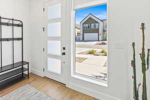 Entryway featuring baseboards and wood finished floors
